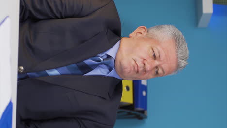 Vertical-video-of-Sleepy-businessman-yawns-looking-at-camera.